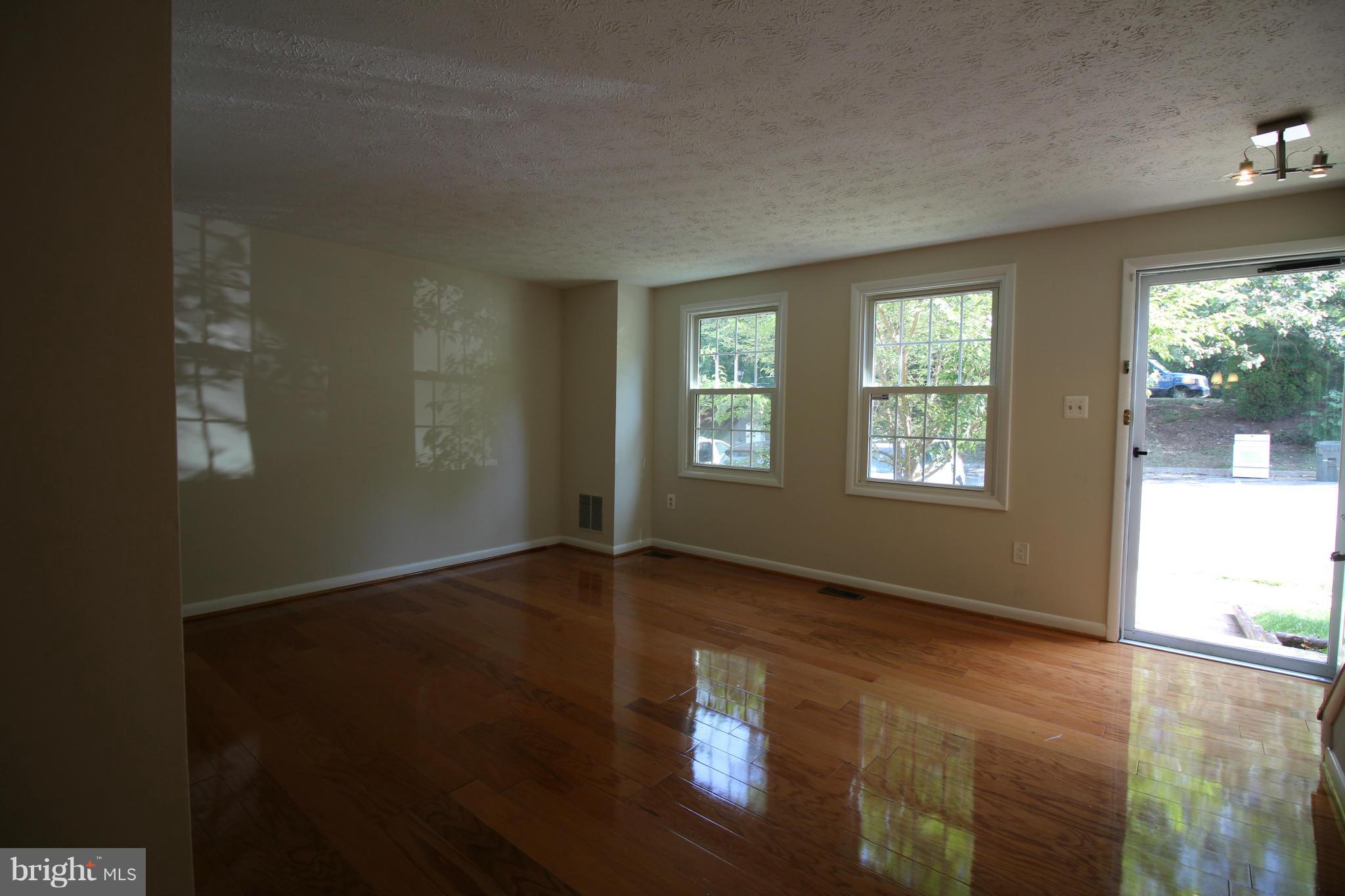 6266 Hillside Road Springfield, VA 22152 - Photo 3 of 29 an empty room with wooden floor and windows