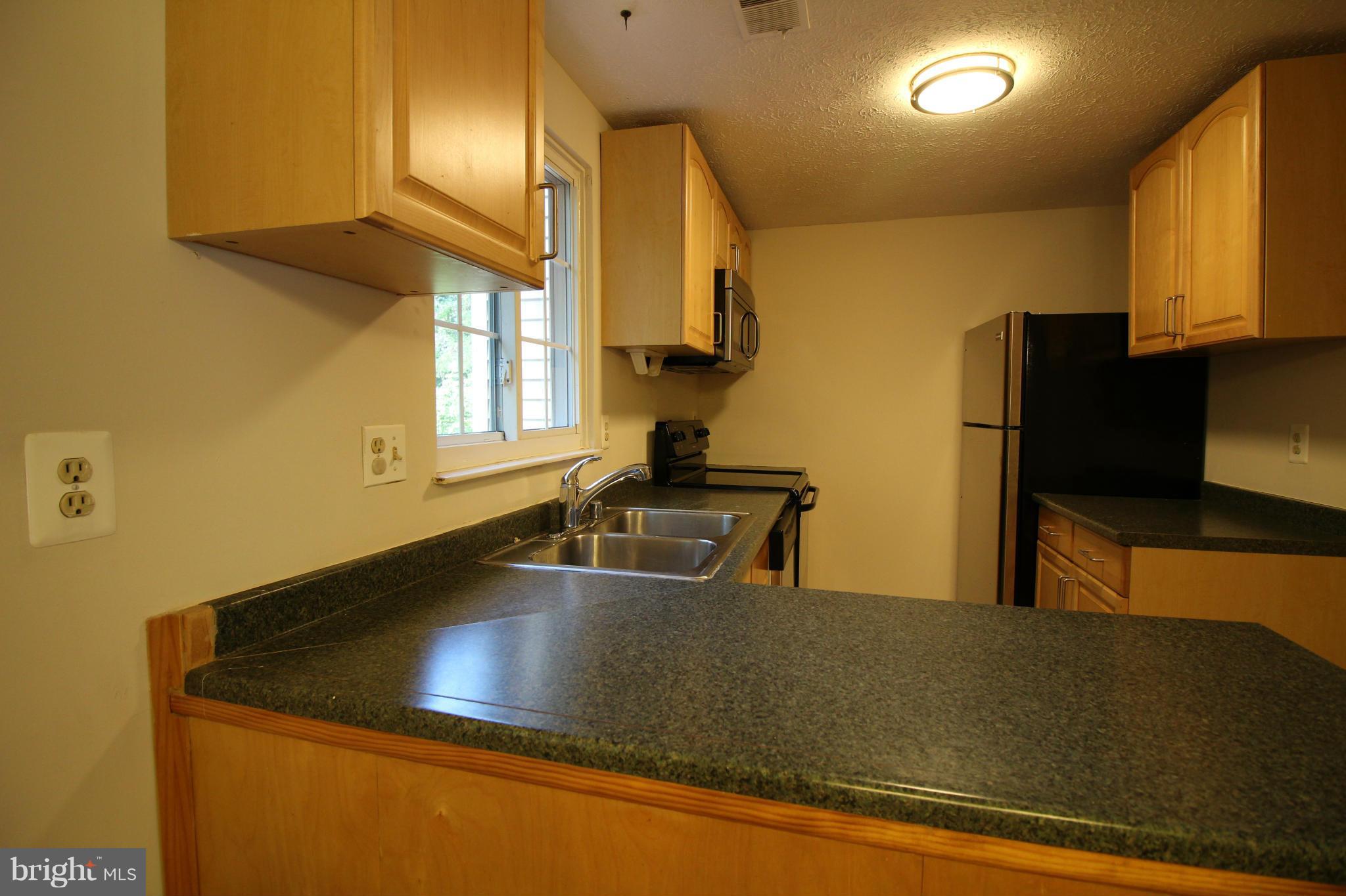 6266 Hillside Road Springfield, VA 22152 - Photo 8 of 29 a kitchen with a sink a counter top space and cabinets