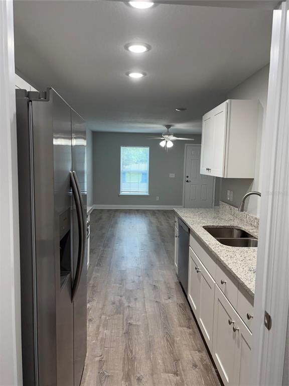 520 2nd Street Southwest Fort Meade, FL 33841 - Photo 12 of 21 a kitchen with granite countertop a sink stove and refrigerator