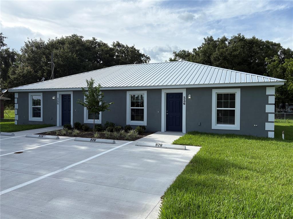 520 2nd Street Southwest Fort Meade, FL 33841 - Photo 19 of 21 a front view of a house with a garden and porch
