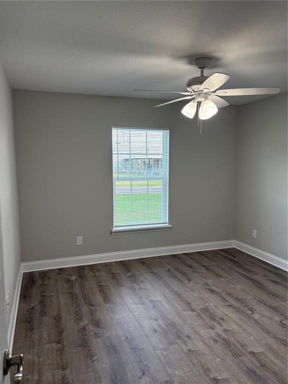 520 2nd Street Southwest Fort Meade, FL 33841 - Photo 3 of 21 wooden floor in an empty room with a window