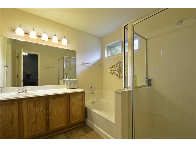 11612 Timber Heights Drive Austin, TX 78754 - Photo 15 of 28 A well-lit bathroom provides both a soaking tub and a separate glass-enclosed shower.