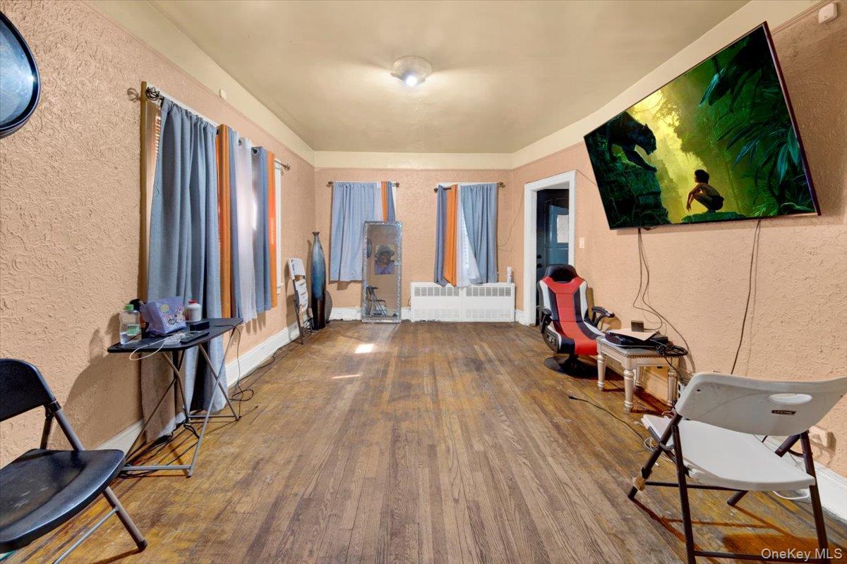 4122 Wickham Avenue Bronx, NY 10466 - Photo 3 of 10 a view of a livingroom with furniture and a flat screen tv