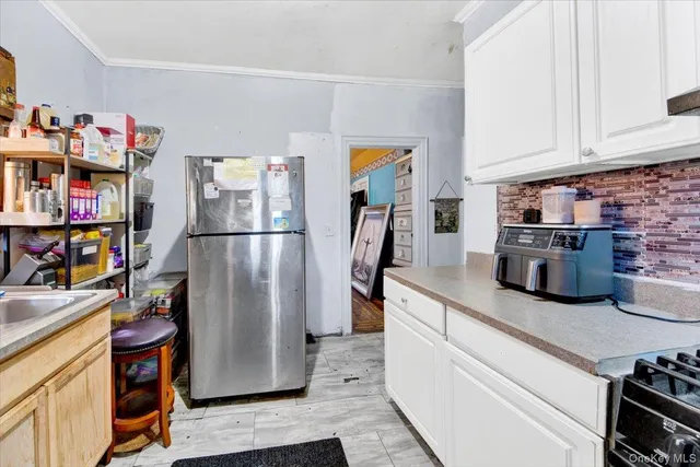 a kitchen with stainless steel appliances granite countertop a refrigerator a stove and a sink with cabinets