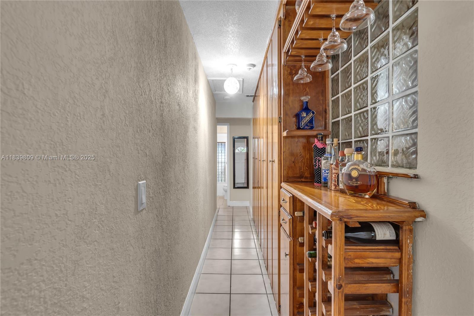 2121 Southwest 13th Avenue Miami, FL 33145 - Photo 11 of 43 a hallway with a white stove top oven and cabinets