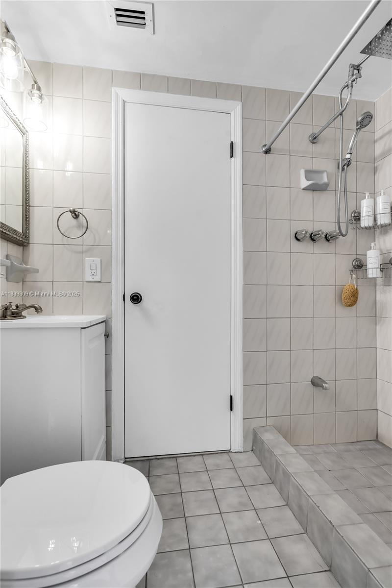 2121 Southwest 13th Avenue Miami, FL 33145 - Photo 13 of 43 a bathroom with a toilet a sink and shower