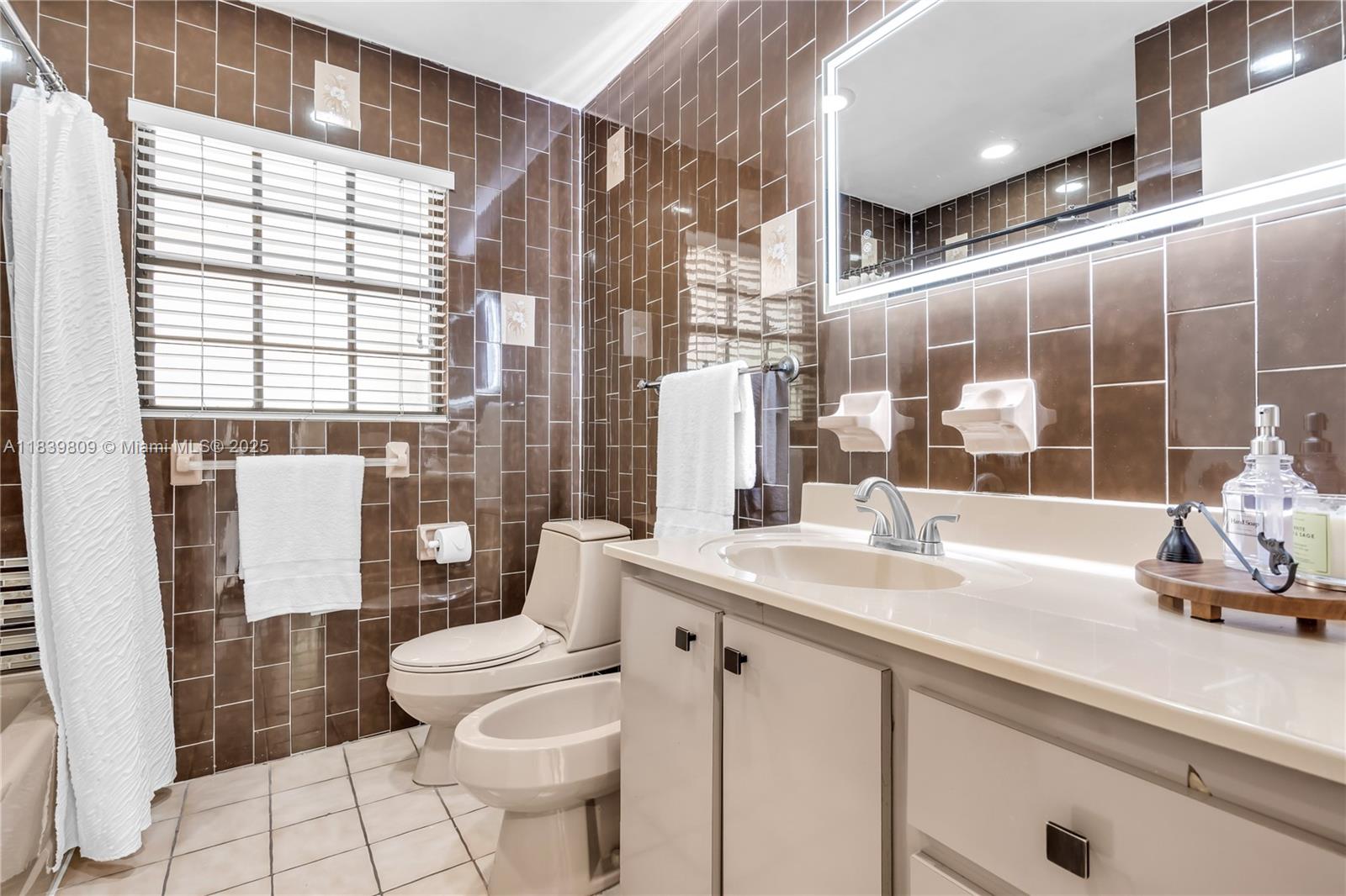 2121 Southwest 13th Avenue Miami, FL 33145 - Photo 21 of 43 a bathroom with a sink a toilet a mirror and shower
