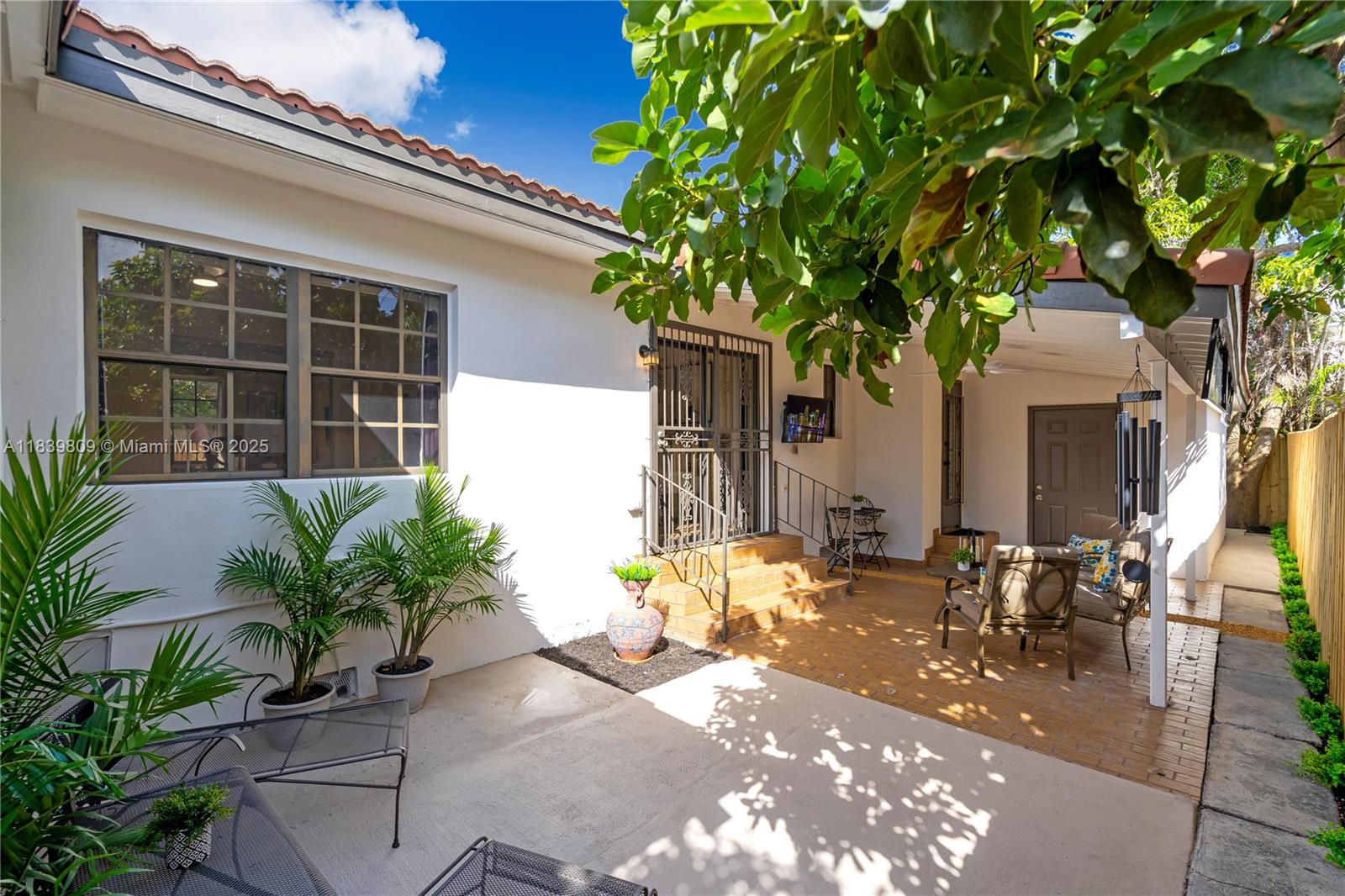 2121 Southwest 13th Avenue Miami, FL 33145 - Photo 25 of 43 a front view of a house with outdoor seating and a tree
