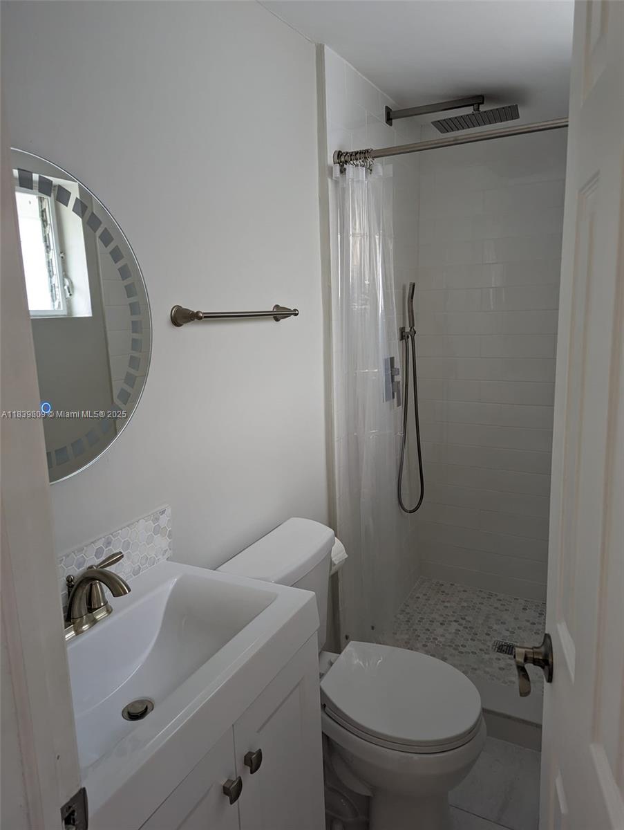 2121 Southwest 13th Avenue Miami, FL 33145 - Photo 38 of 43 a bathroom with a toilet sink and shower