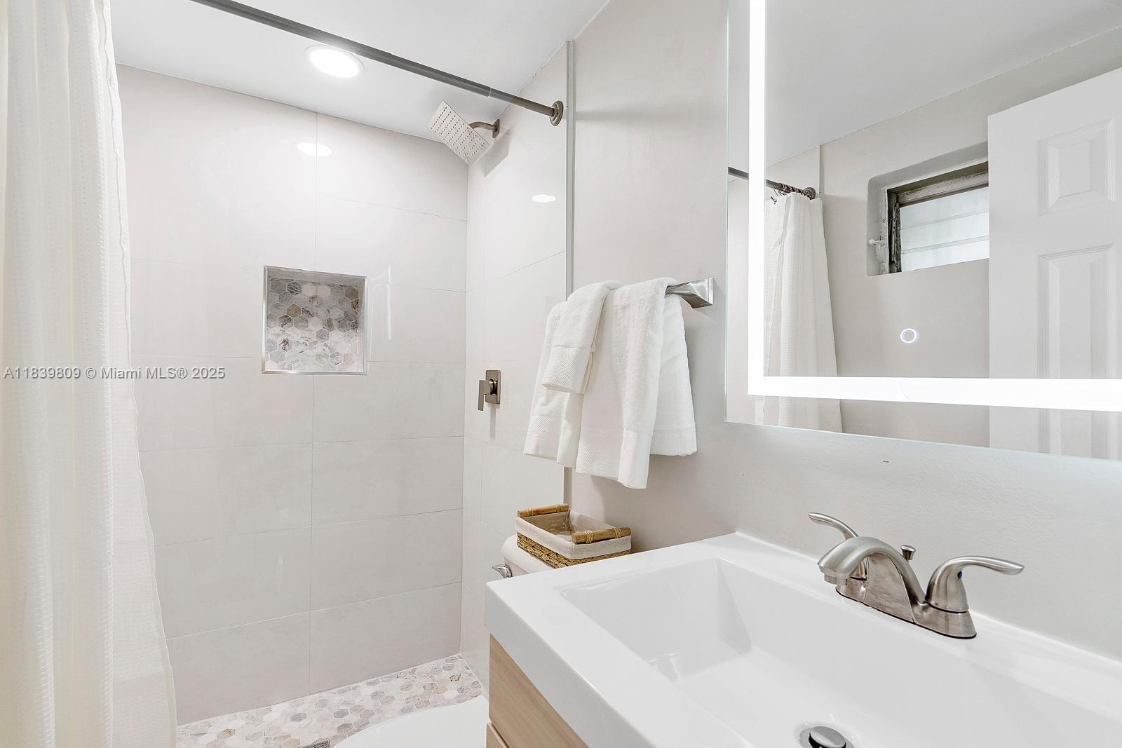 2121 Southwest 13th Avenue Miami, FL 33145 - Photo 42 of 43 a bathroom with a sink and a mirror