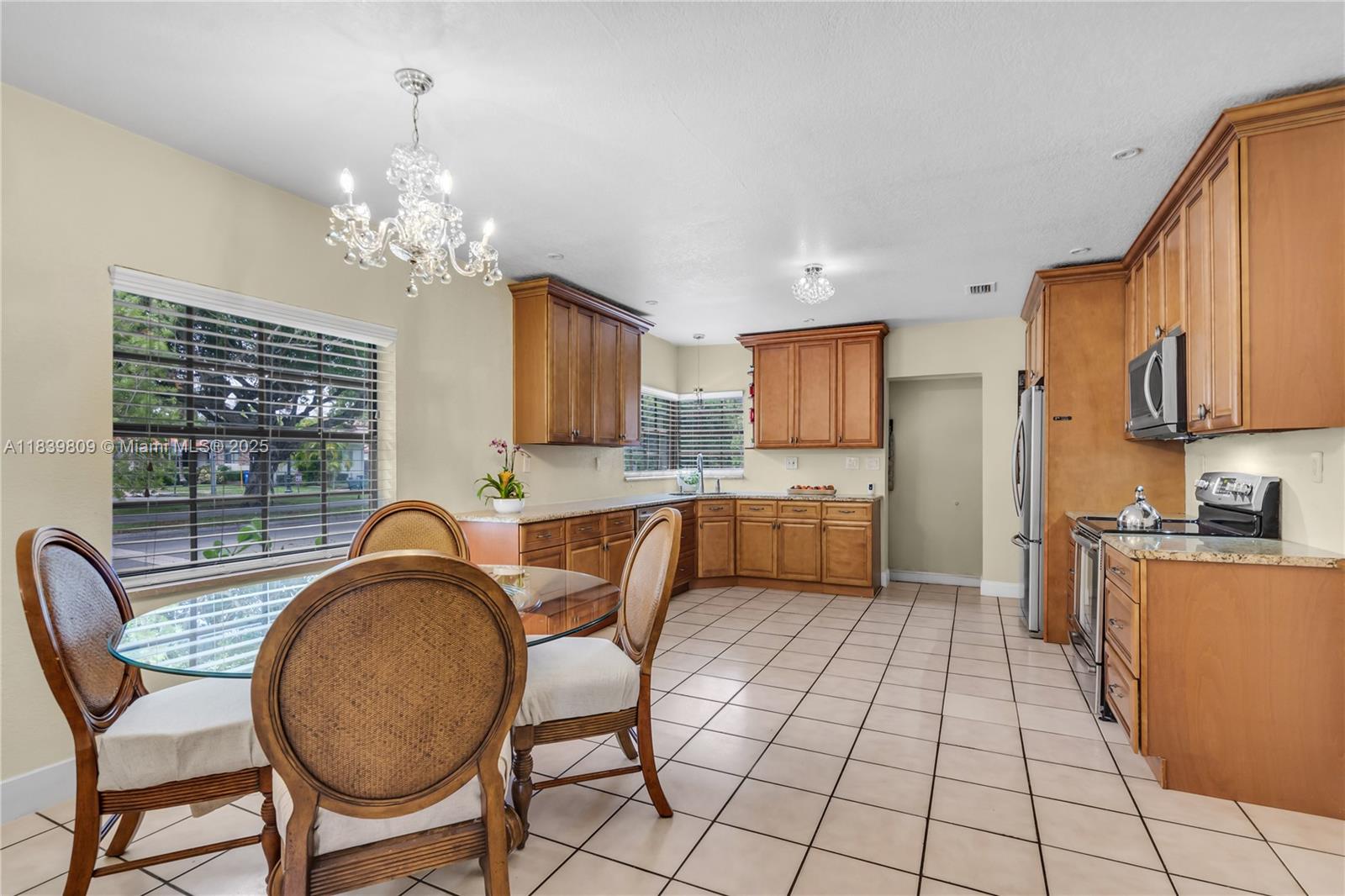 2121 Southwest 13th Avenue Miami, FL 33145 - Photo 8 of 43 a view of a dining room with furniture a chandelier and window