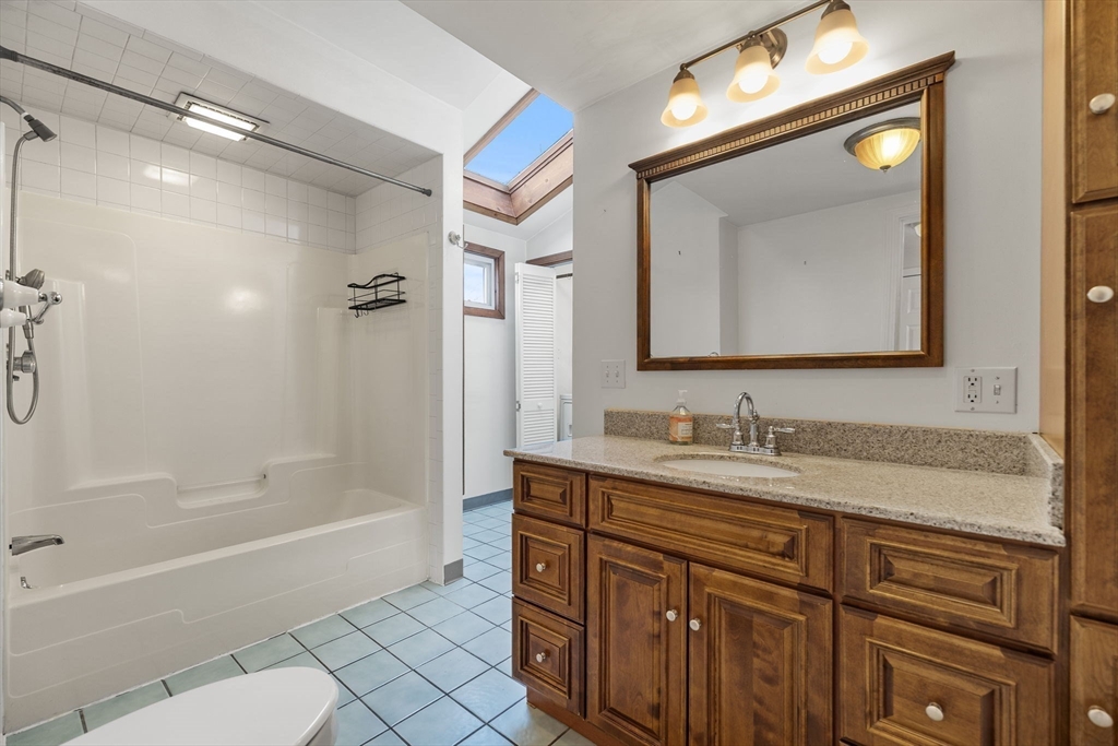 12 Wright Street, Unit 1 Stoneham, MA 02180 - Photo 12 of 36 a bathroom with a tub a sink and mirror