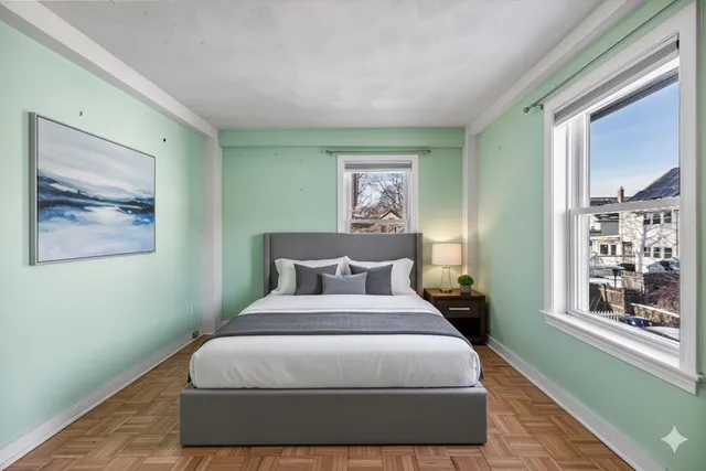 a bedroom with a large bed and a window