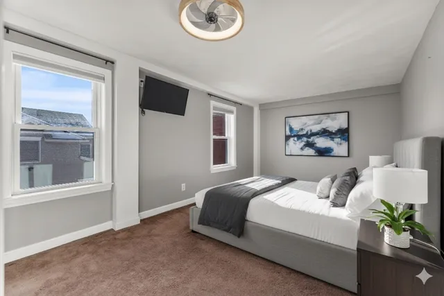 a bedroom with a bed and a painting on the wall