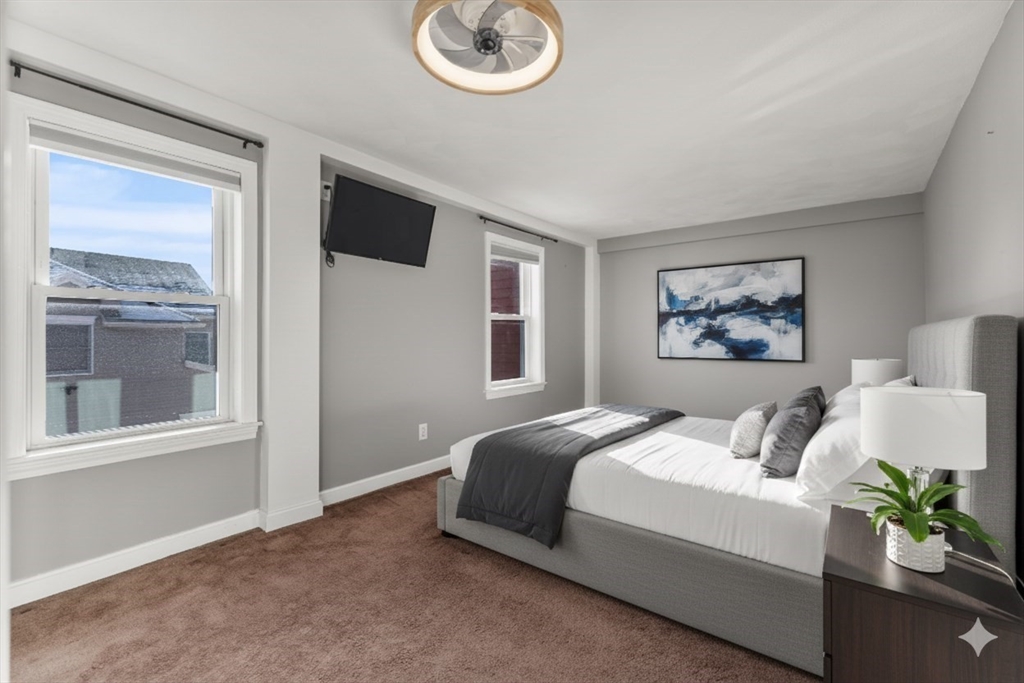 12 Wright Street, Unit 1 Stoneham, MA 02180 - Photo 20 of 36 a bedroom with a bed and a painting on the wall