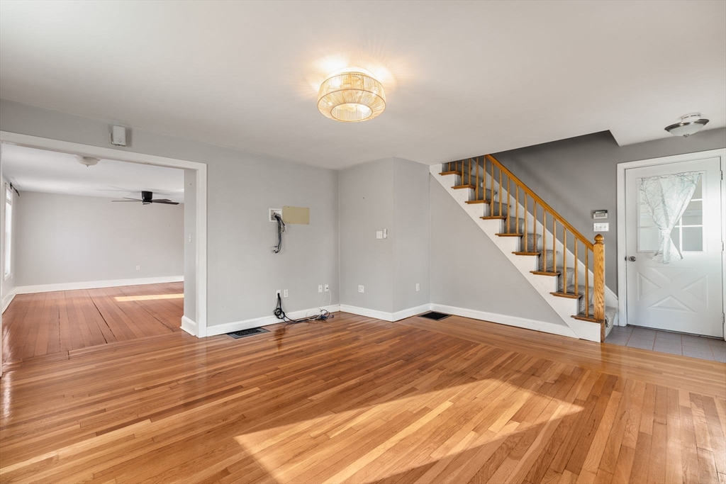 12 Wright Street, Unit 1 Stoneham, MA 02180 - Photo 3 of 36 a view of an empty room with wooden floor and a window