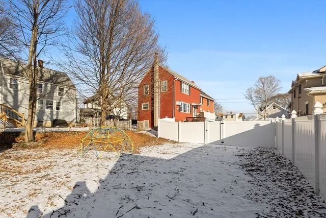 a view of a house with a wooden fence