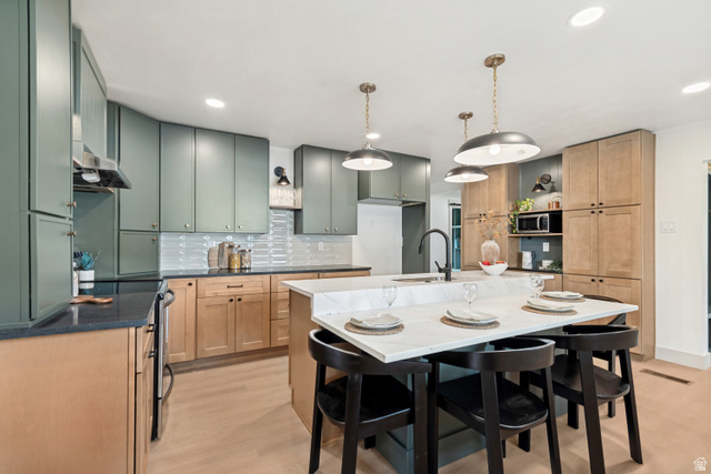 1010 West Maple Street Mapleton, UT 84664 - Photo 7 of 24 Contemporary kitchen featuring an expansive center island with seating, a single basin sink, and pendant lighting