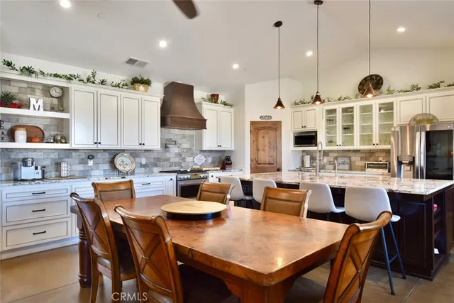 a large kitchen with a table and chairs