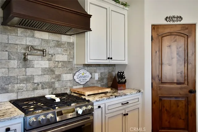 a stove top oven sitting inside of a kitchen