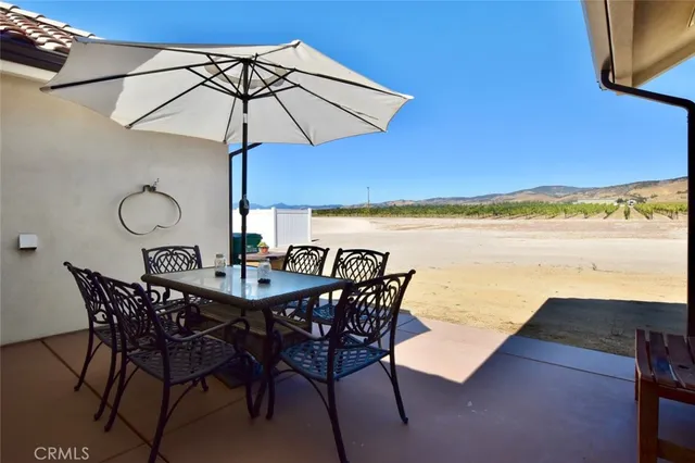 a view of an outdoor space with furniture and umbrella