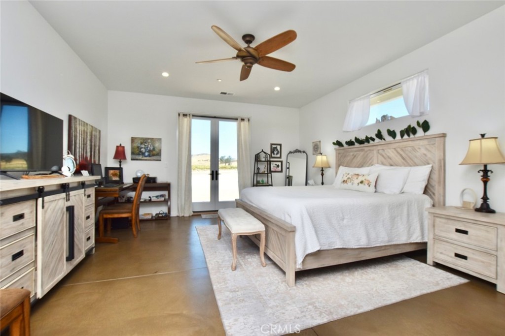 50645 Lockwood Road Lockwood, CA 93426 - Photo 22 of 48 a bedroom with a bed and a chandelier