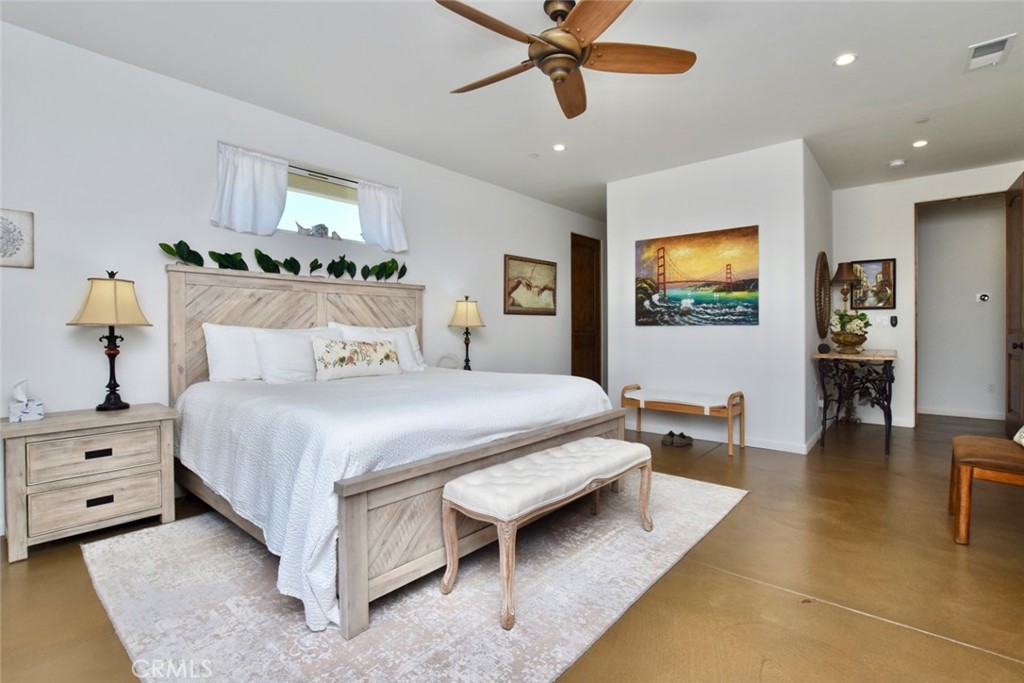 50645 Lockwood Road Lockwood, CA 93426 - Photo 24 of 48 a bedroom with a bed a couch and a flat screen tv