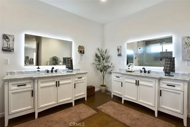 a spacious bathroom with a granite countertop sink mirror and a toilet