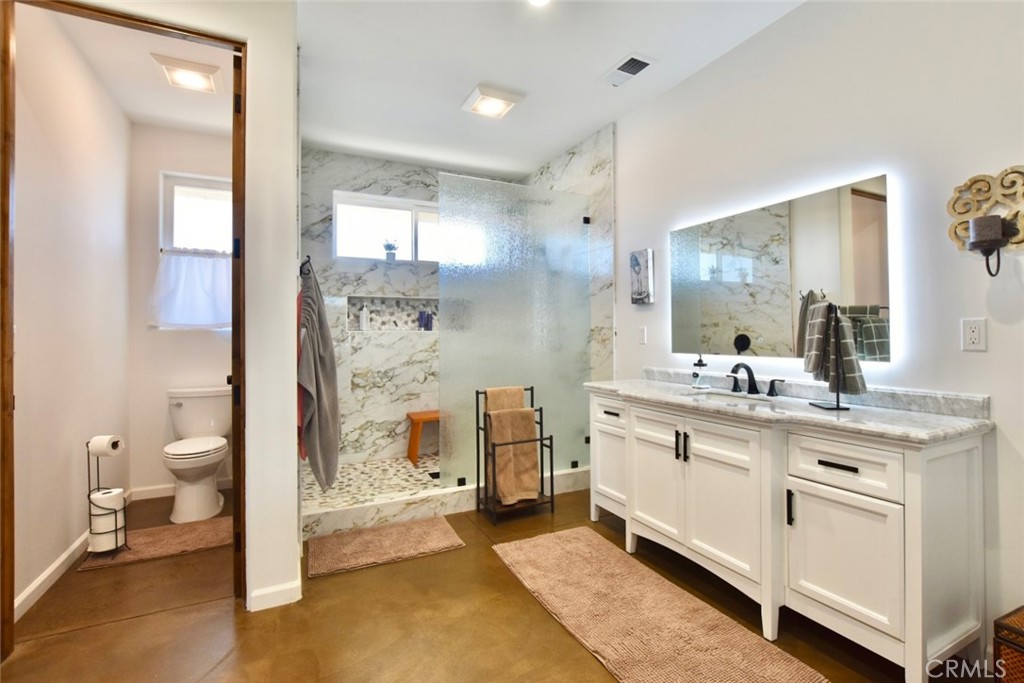 50645 Lockwood Road Lockwood, CA 93426 - Photo 27 of 48 a spacious bathroom with a granite countertop sink mirror and a toilet