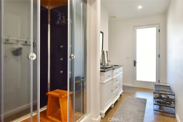 a bathroom with a glass shower door
