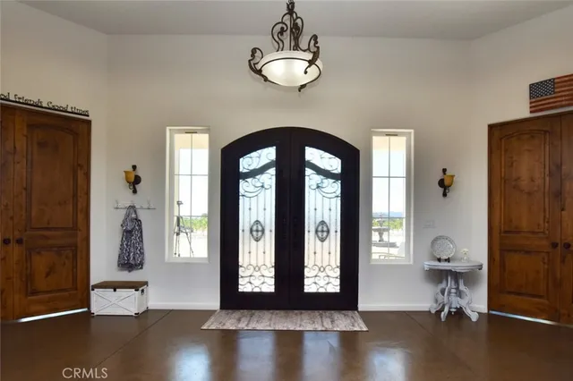 a view of a livingroom with furniture window wooden floor and front door