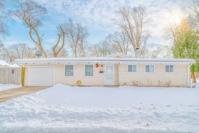 a white house that has a tree in front of it