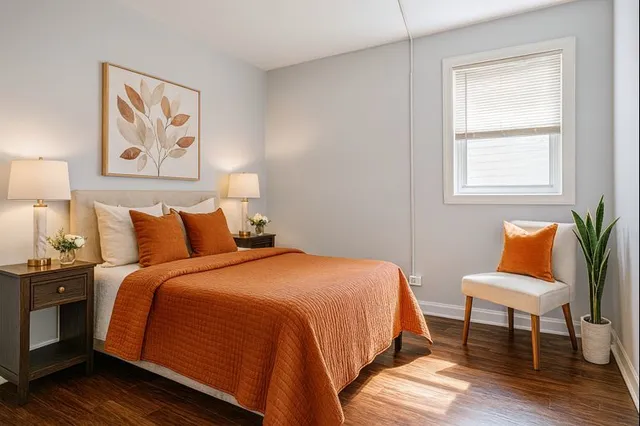 a bedroom with bed and a painting on the wall