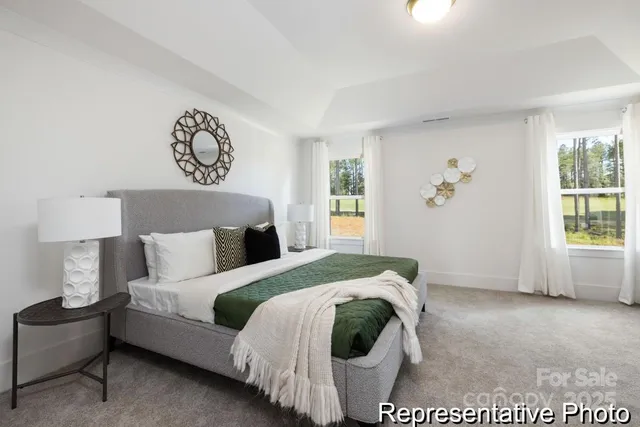 a spacious bedroom with a bed and a window