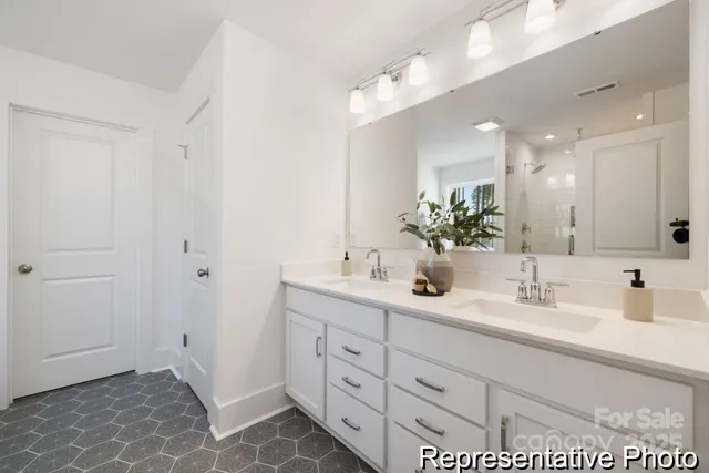 a bathroom with a double vanity sink and a mirror