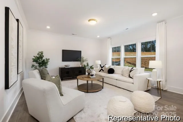 a living room with furniture a large window and a flat screen tv