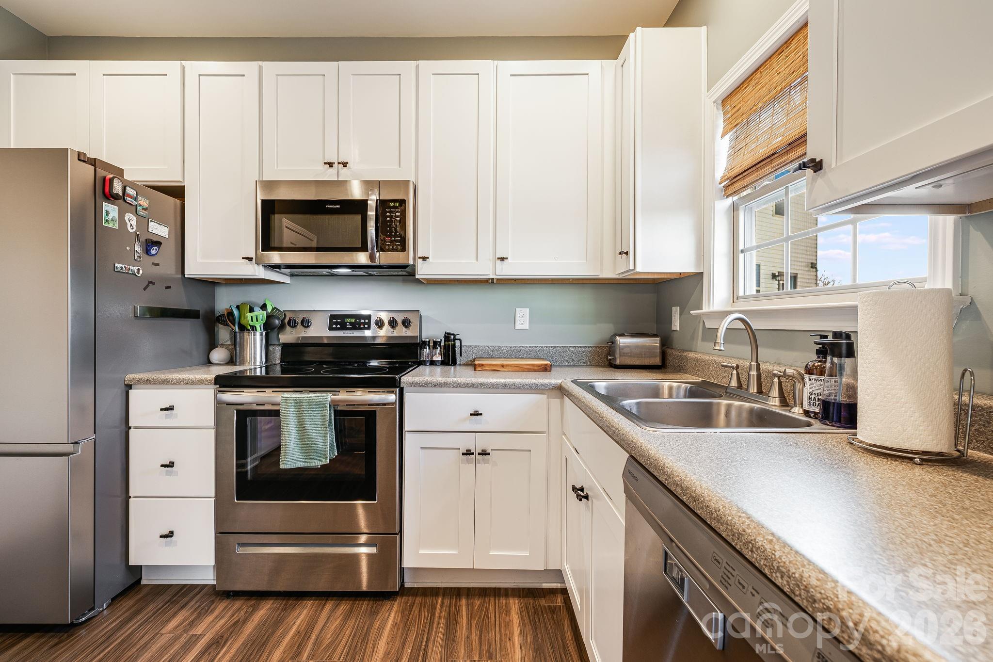 486 Cardwell Lane Fletcher, NC 28732 - Photo 11 of 35 a kitchen with stainless steel appliances white cabinets and a sink