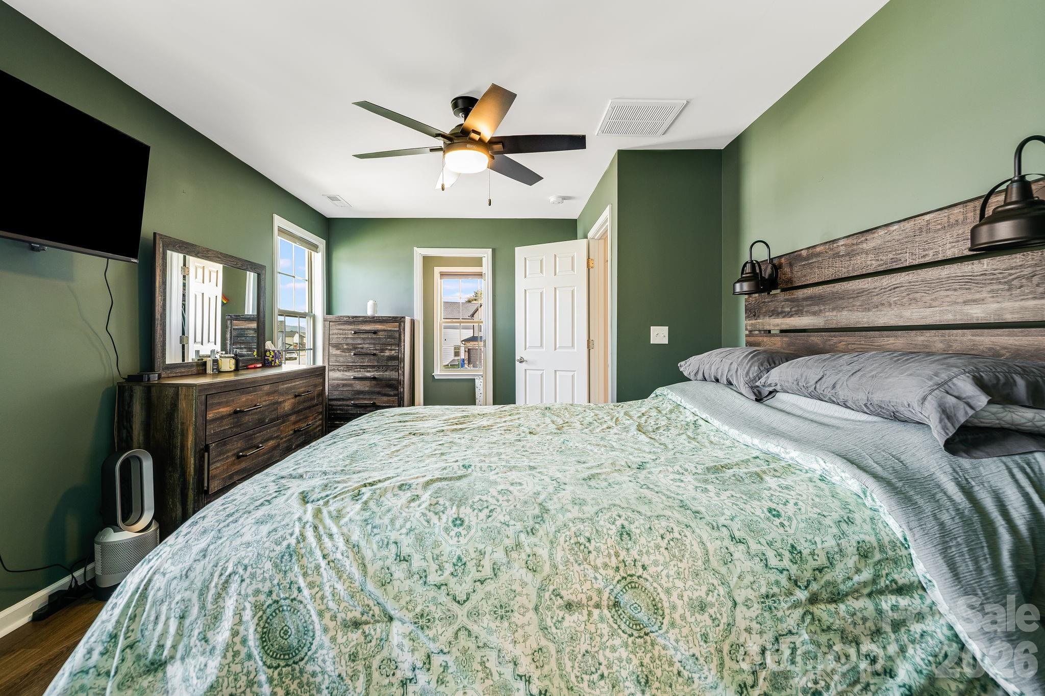 486 Cardwell Lane Fletcher, NC 28732 - Photo 16 of 35 a bedroom with a bed and a flat screen tv