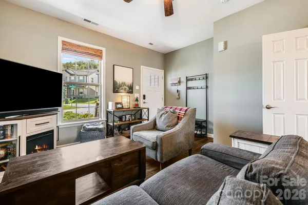 a living room with furniture fireplace and flat screen tv