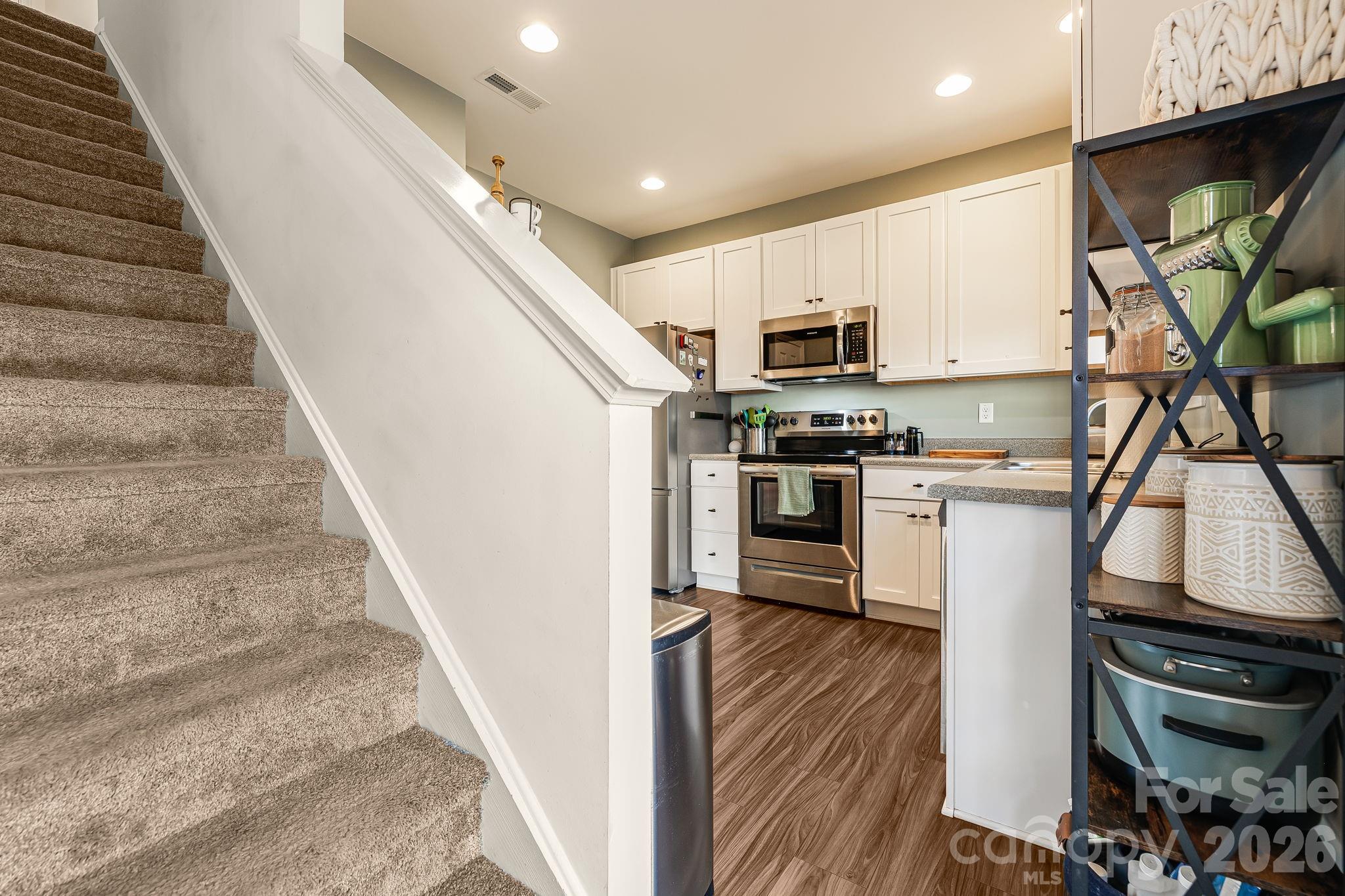 486 Cardwell Lane Fletcher, NC 28732 - Photo 10 of 35 a kitchen with stainless steel appliances granite countertop a stove a sink and a refrigerator