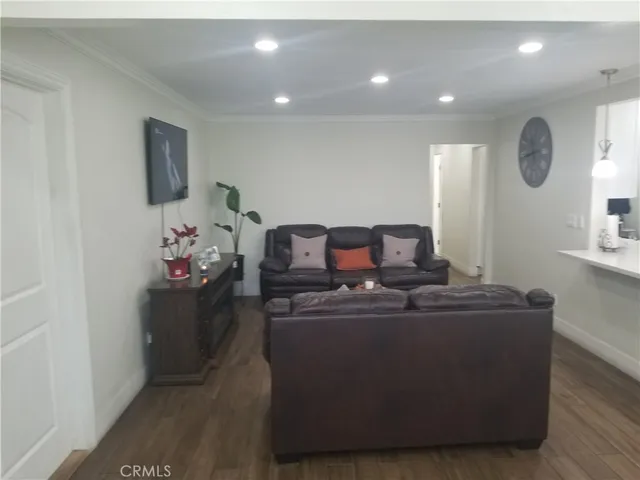a living room with furniture and a mirror