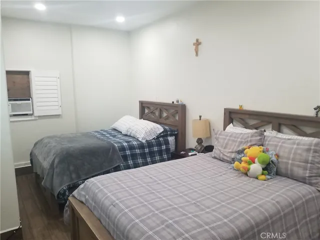 a bedroom with two beds and a window