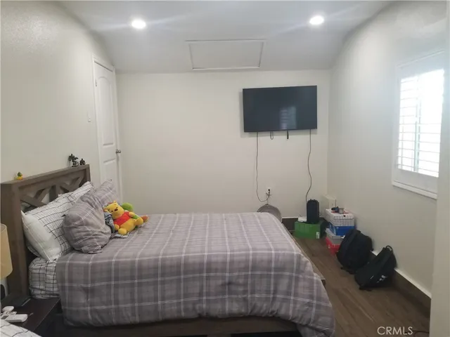 a bedroom with a bed and flat screen tv