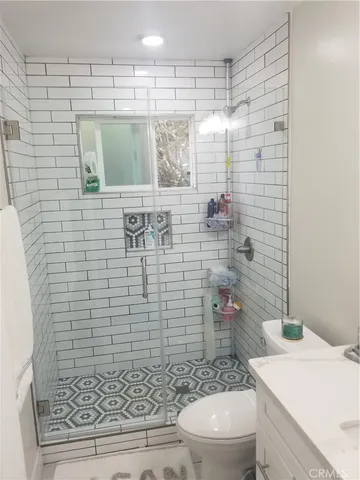 a bathroom with a shower a toilet and a sink