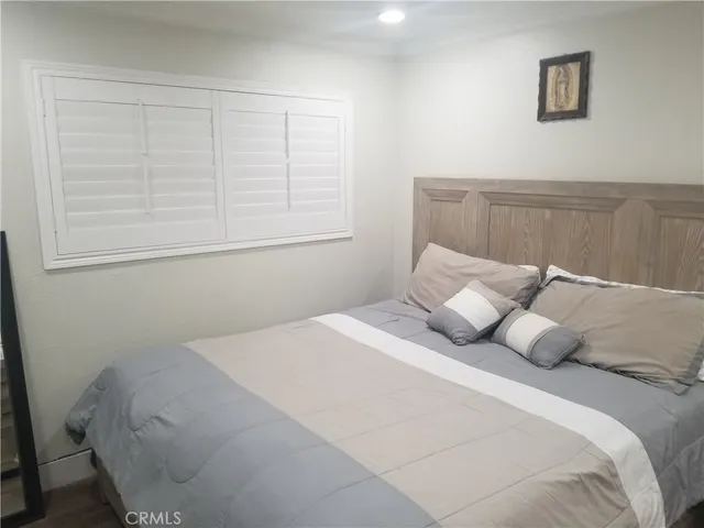 a bedroom with a bed and a window