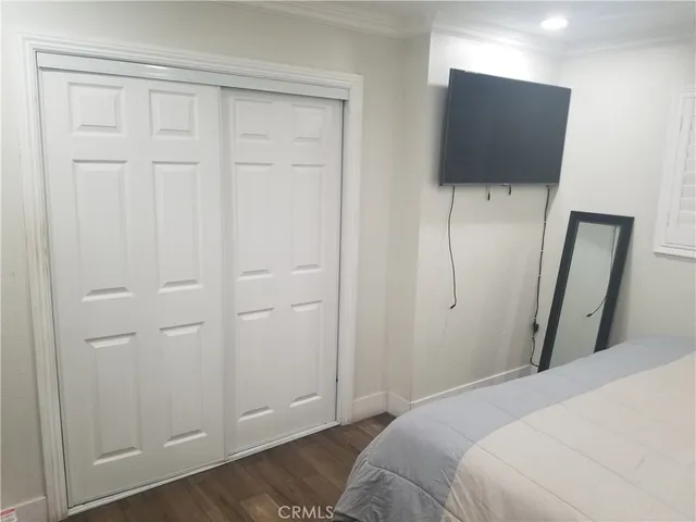 a bedroom with a bed and a flat tv screen