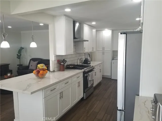 a kitchen with stainless steel appliances granite countertop a sink and cabinets