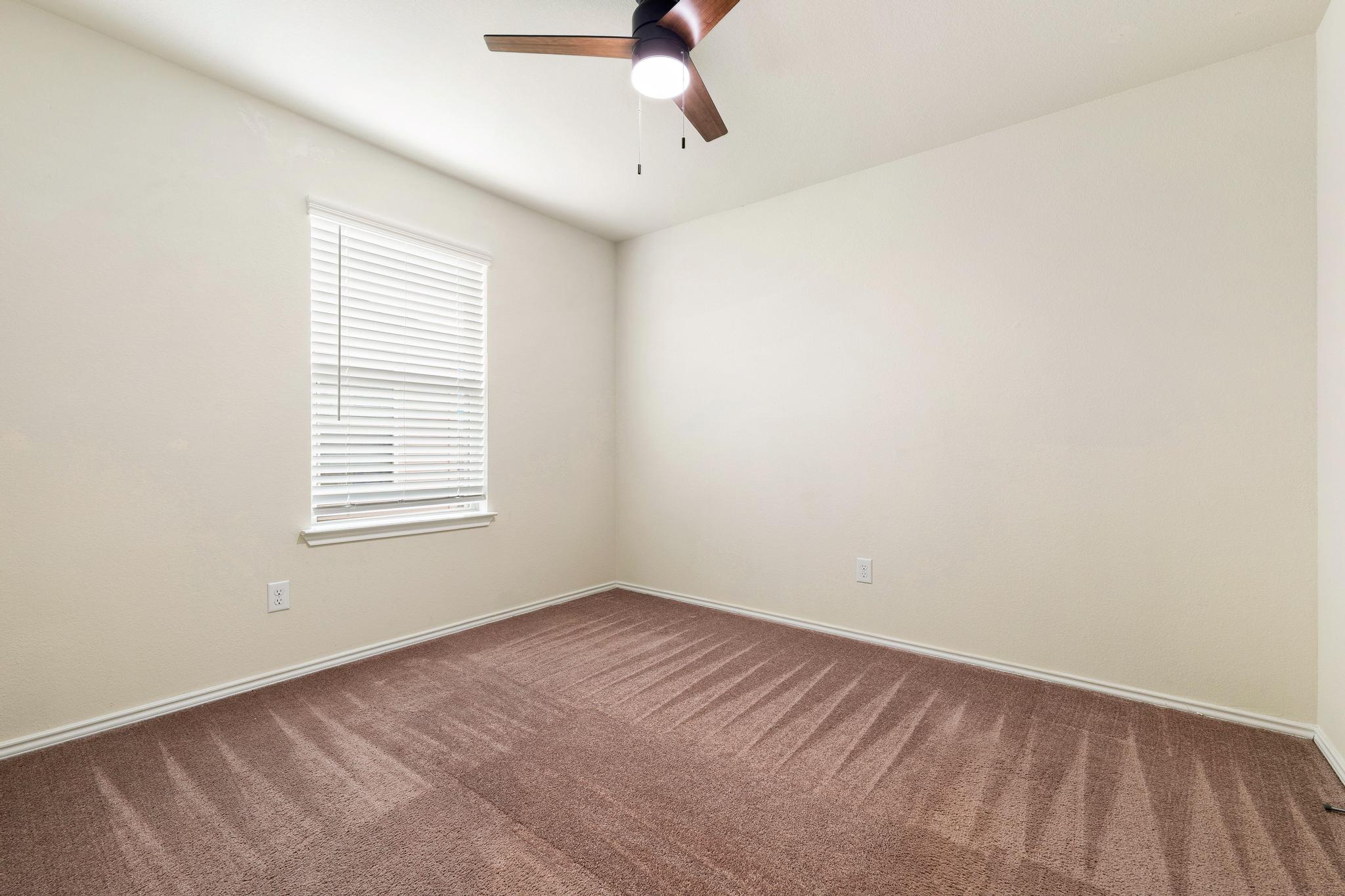 217 Innisfree Road Jarrell, TX 76537 - Photo 31 of 39 A well-proportioned bedroom with ample natural light and a comforting ceiling fan for year-round comfort.