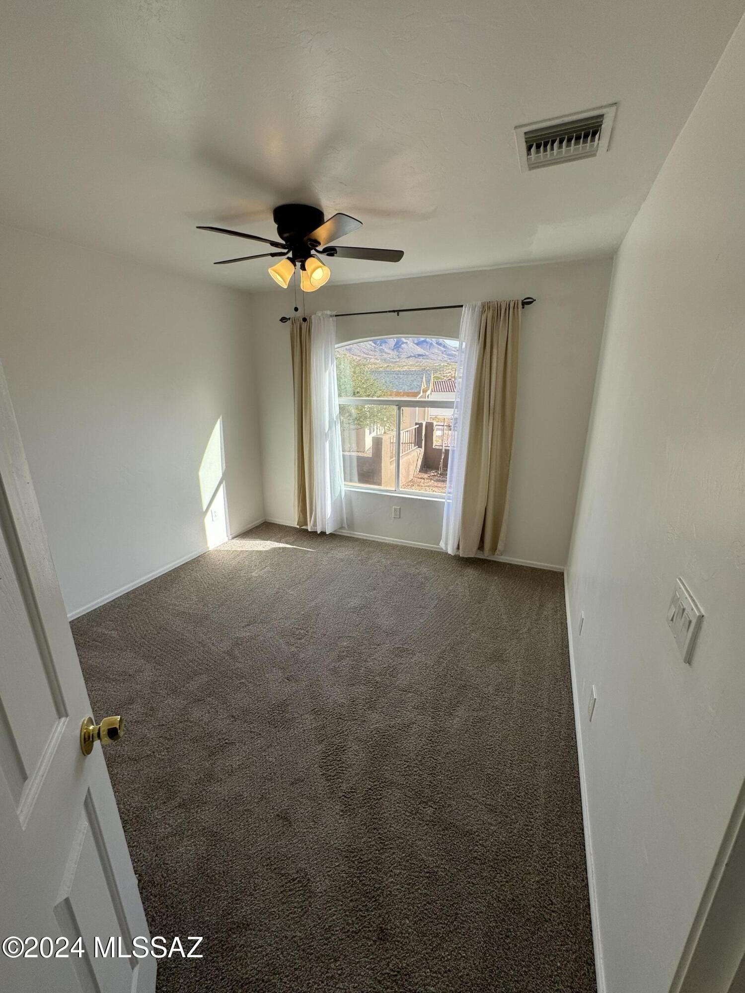 1841 America Court Rio Rico, AZ 85648 - Photo 9 of 38 a view of a livingroom with a ceiling fan and window
