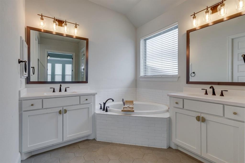 9613 Boulder Pt Road Oak Point, TX 75068 - Photo 20 of 28 Bathroom featuring twin white vanities with integrated sinks, framed mirrors, and overhead lighting fixtures